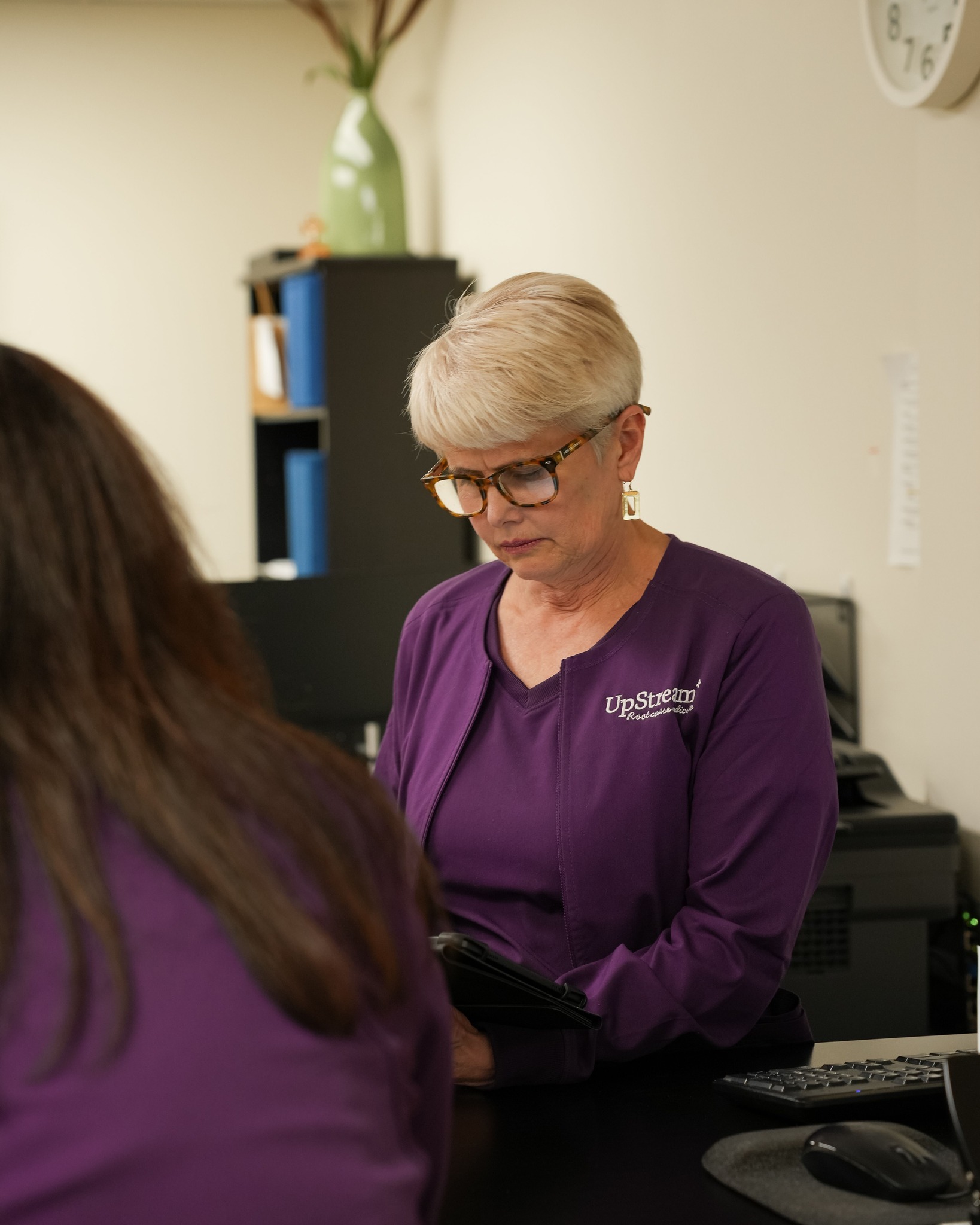 Functional medicine practitioner reviewing patient information during consultation for brain fog after 40 and cognitive health evaluation