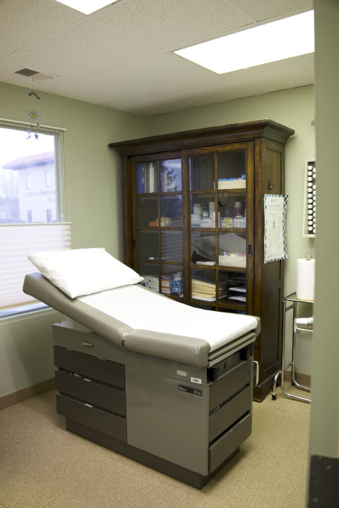 Quiet exam room with an examination table and medical supplies in a clinic environment related to brain fog Omaha evaluations.