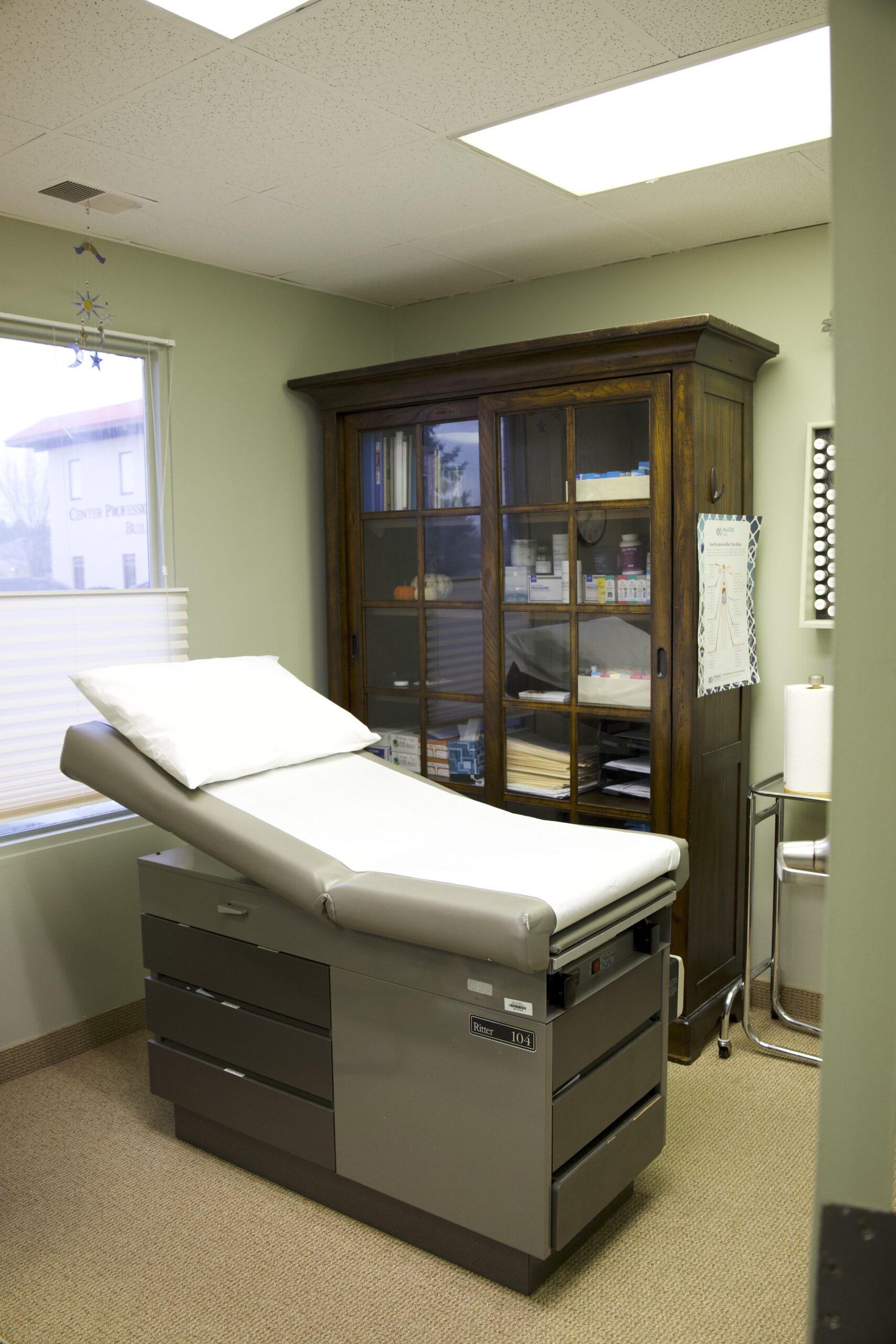 Quiet exam room with an examination table and medical supplies in a clinic environment related to brain fog Omaha evaluations.