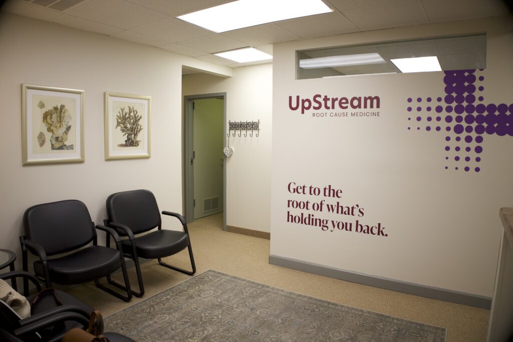 Waiting area inside an Omaha clinic focused on functional medicine gut health, featuring UpStream Root Cause Medicine signage.