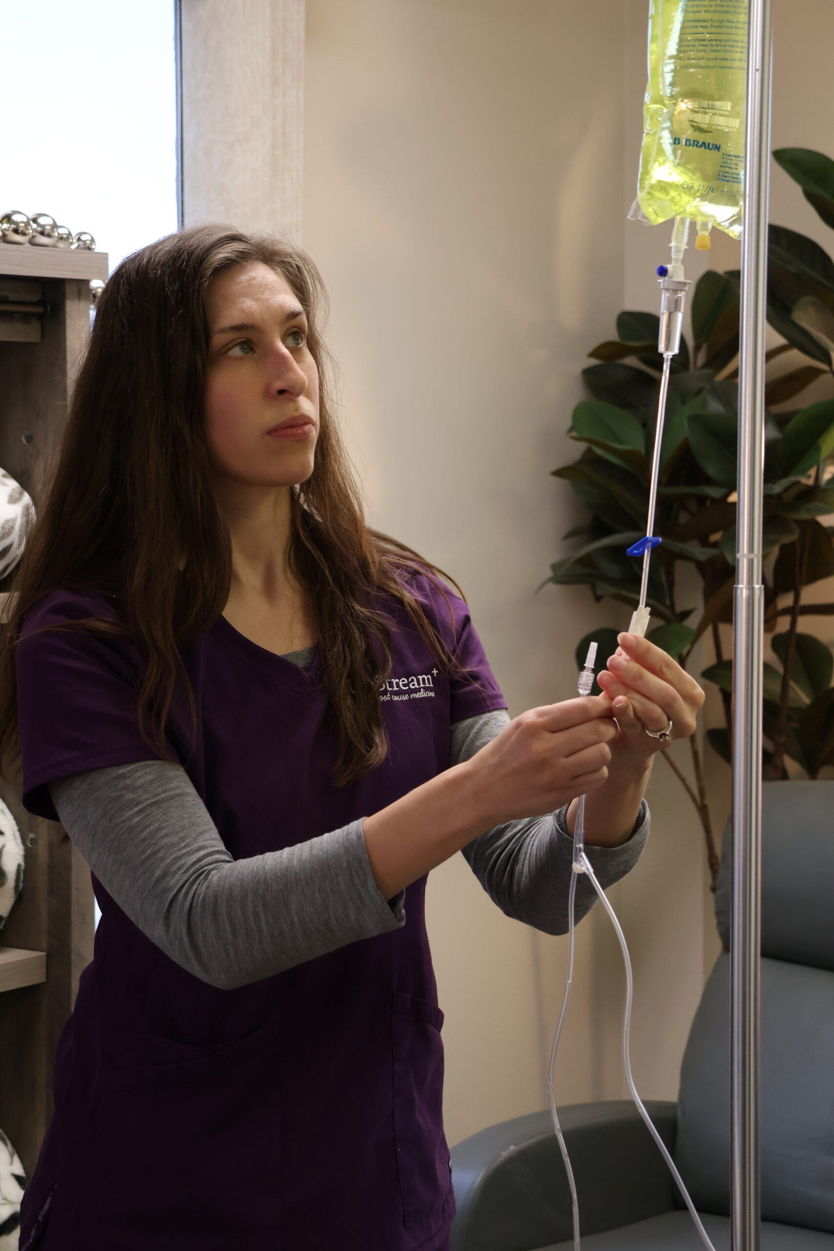 Clinician at UpStream preparing an IV infusion as part of a gut health Omaha care setting focused on whole-person support.