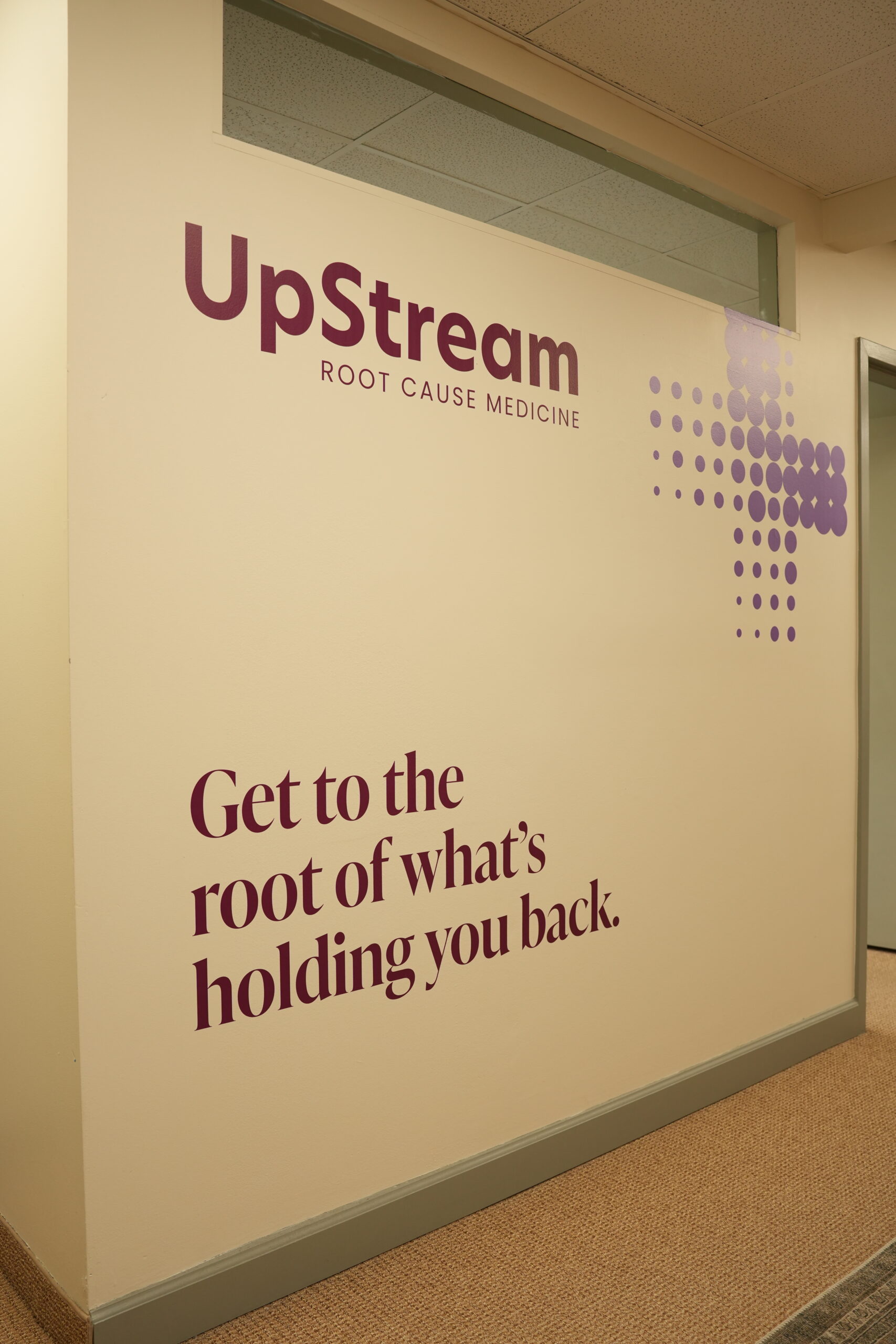 UpStream Root Cause Medicine clinic wall in Omaha, representing a systems-based approach to stress hormone imbalance and root-cause health care.