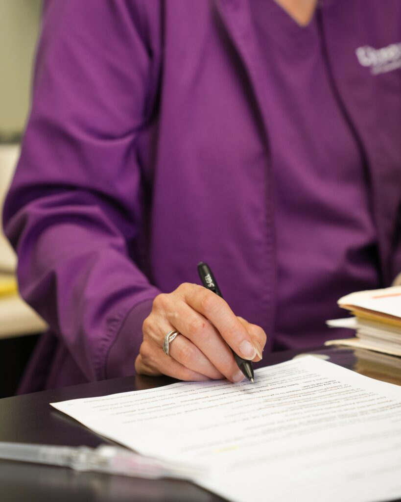 Functional medicine practitioner reviewing patient paperwork during consultation for tired after sleeping and sleep quality evaluation