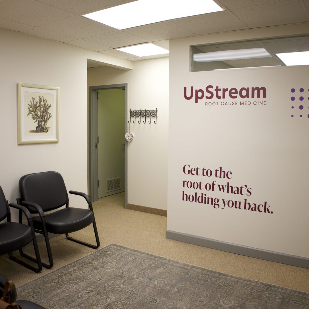 Waiting area inside an Omaha clinic focused on functional medicine gut health, featuring UpStream Root Cause Medicine signage.