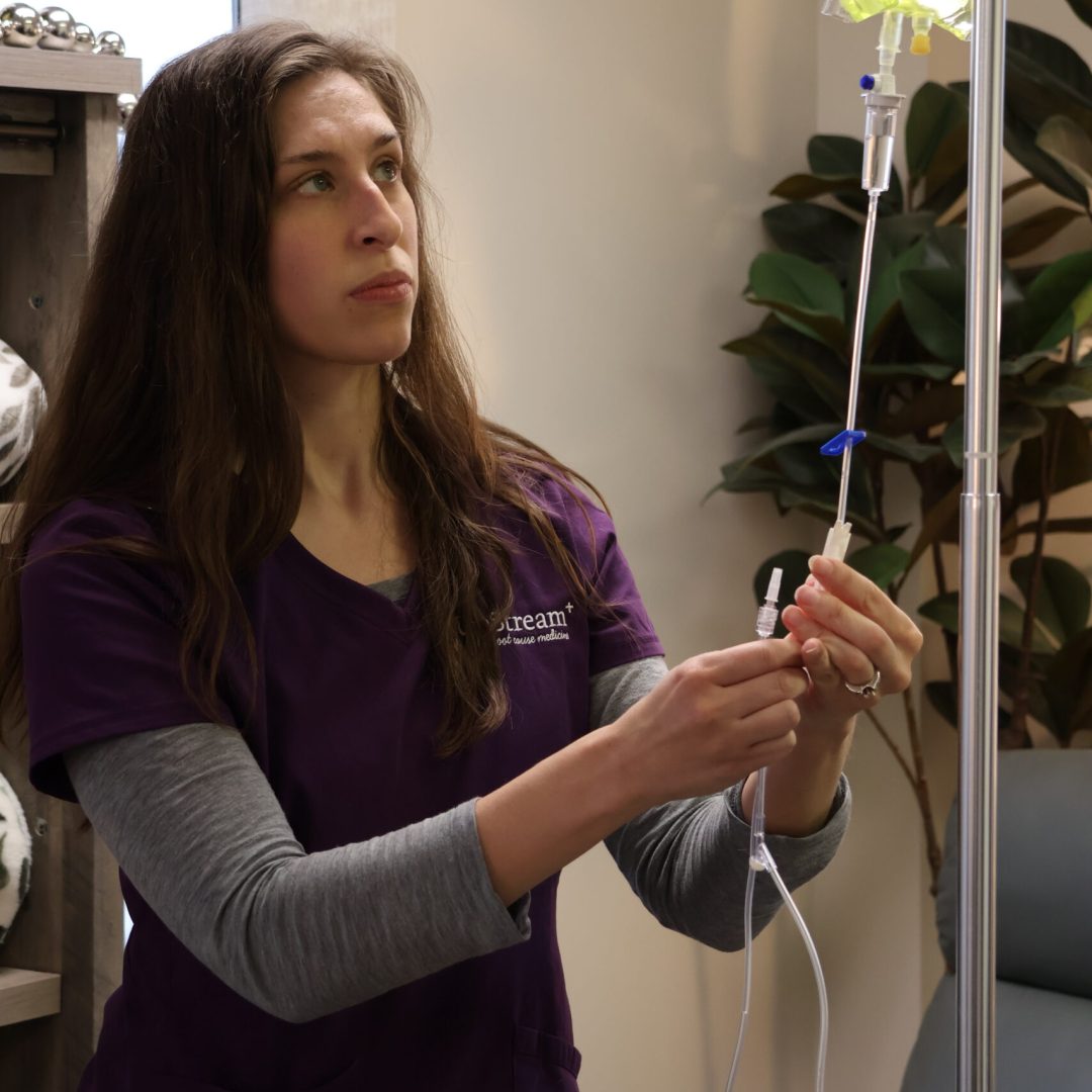 Clinician at UpStream preparing an IV infusion as part of a gut health Omaha care setting focused on whole-person support.