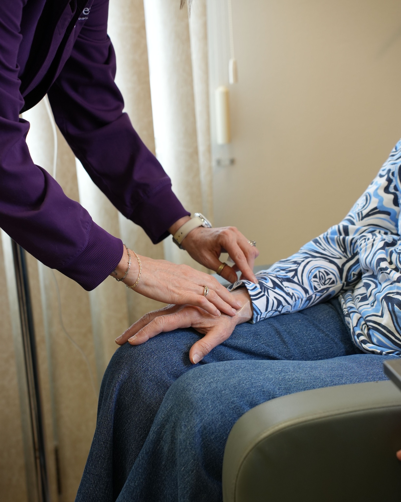 Functional medicine practitioner checking pulse during patient consultation for fatigue after 40 and hormone balance assessment