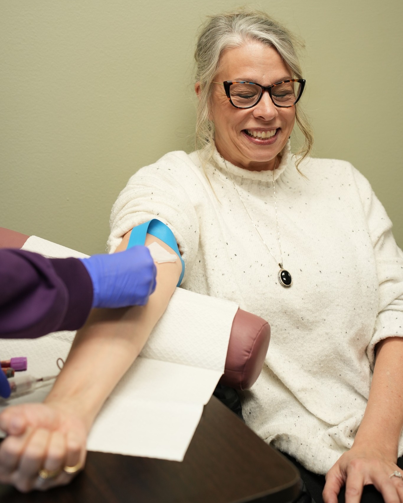 Patient undergoing blood draw at functional medicine clinic in Nebraska for root-cause evaluation