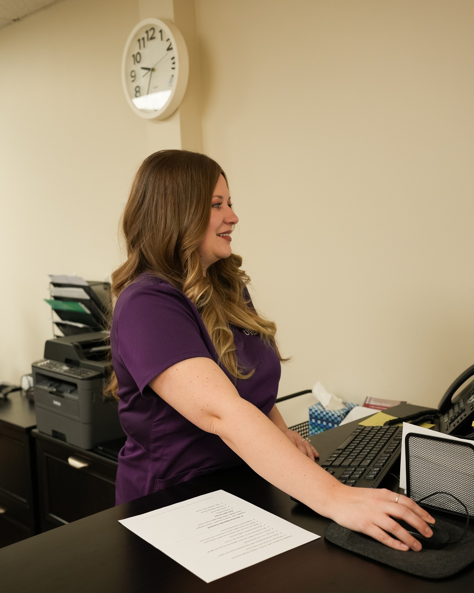 Upstream staff member working at a medical office desk while supporting patient care and ozone Omaha NE appointment coordination.