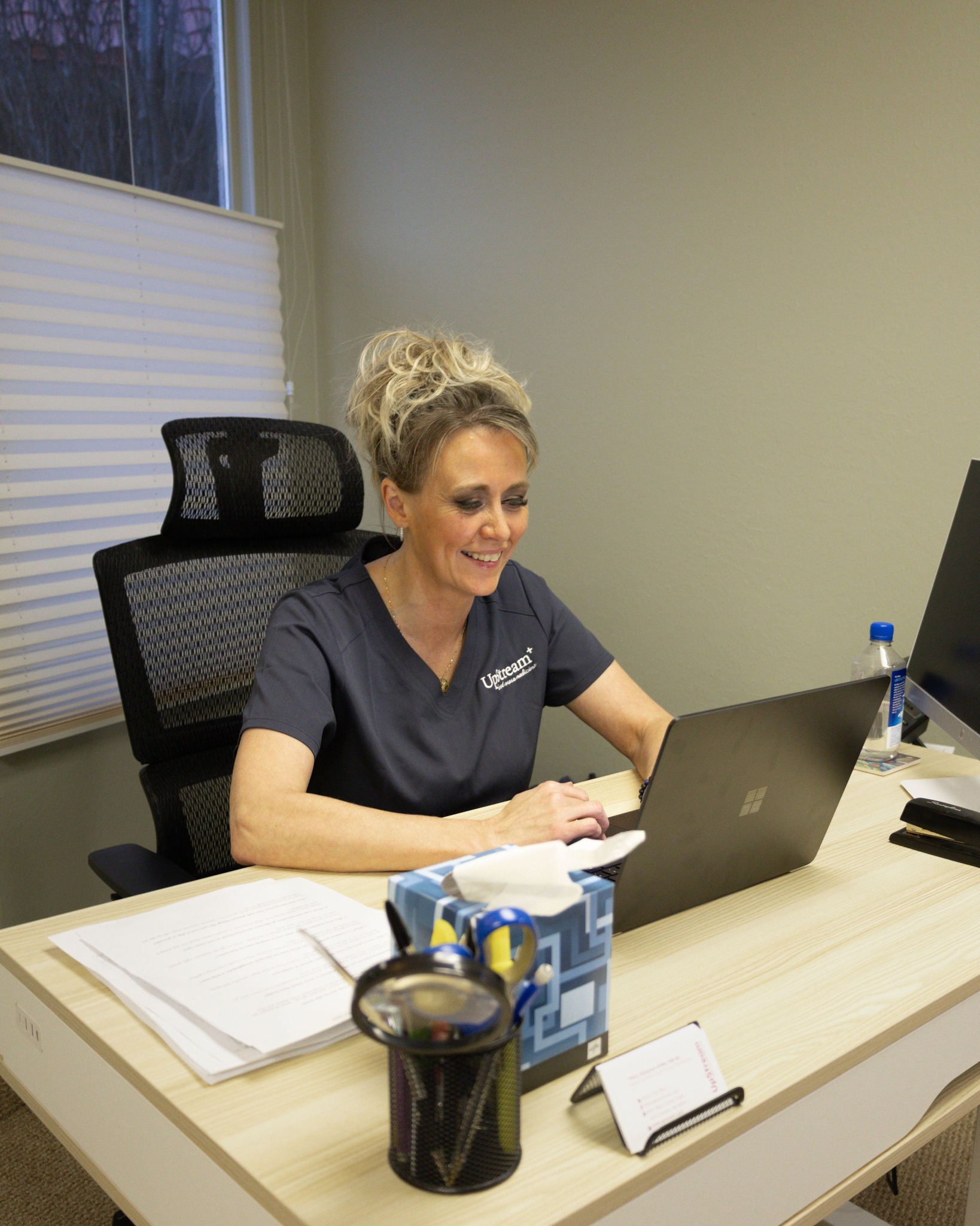 Healthcare provider at Upstream Root Cause Medicine in Omaha consulting with a patient on peptide therapy and personalized wellness plan