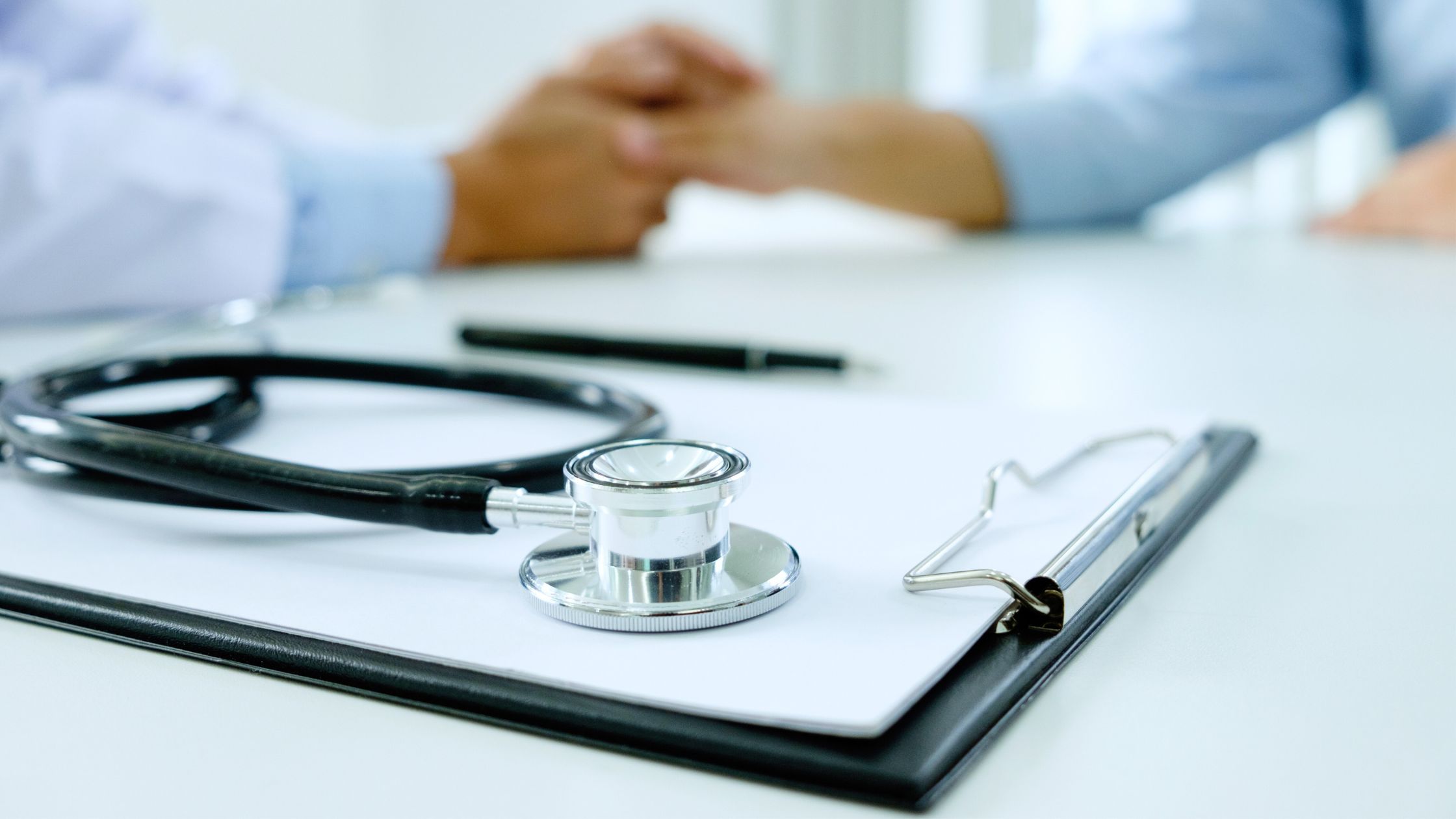 Stethoscope and clipboard in a clinical setting representing evaluation of root causes of fatigue Omaha patients experience.