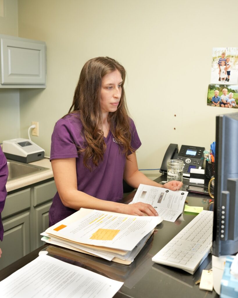 Functional medicine practitioner reviewing patient information during consultation for nervous system imbalance and difficulty relaxing